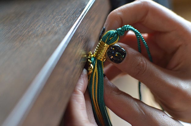 Close the tassel clasp after installing the new year charm
