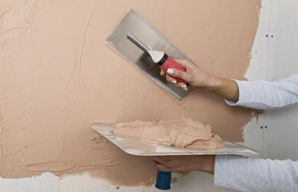 A mortar board tool used to plaster walls