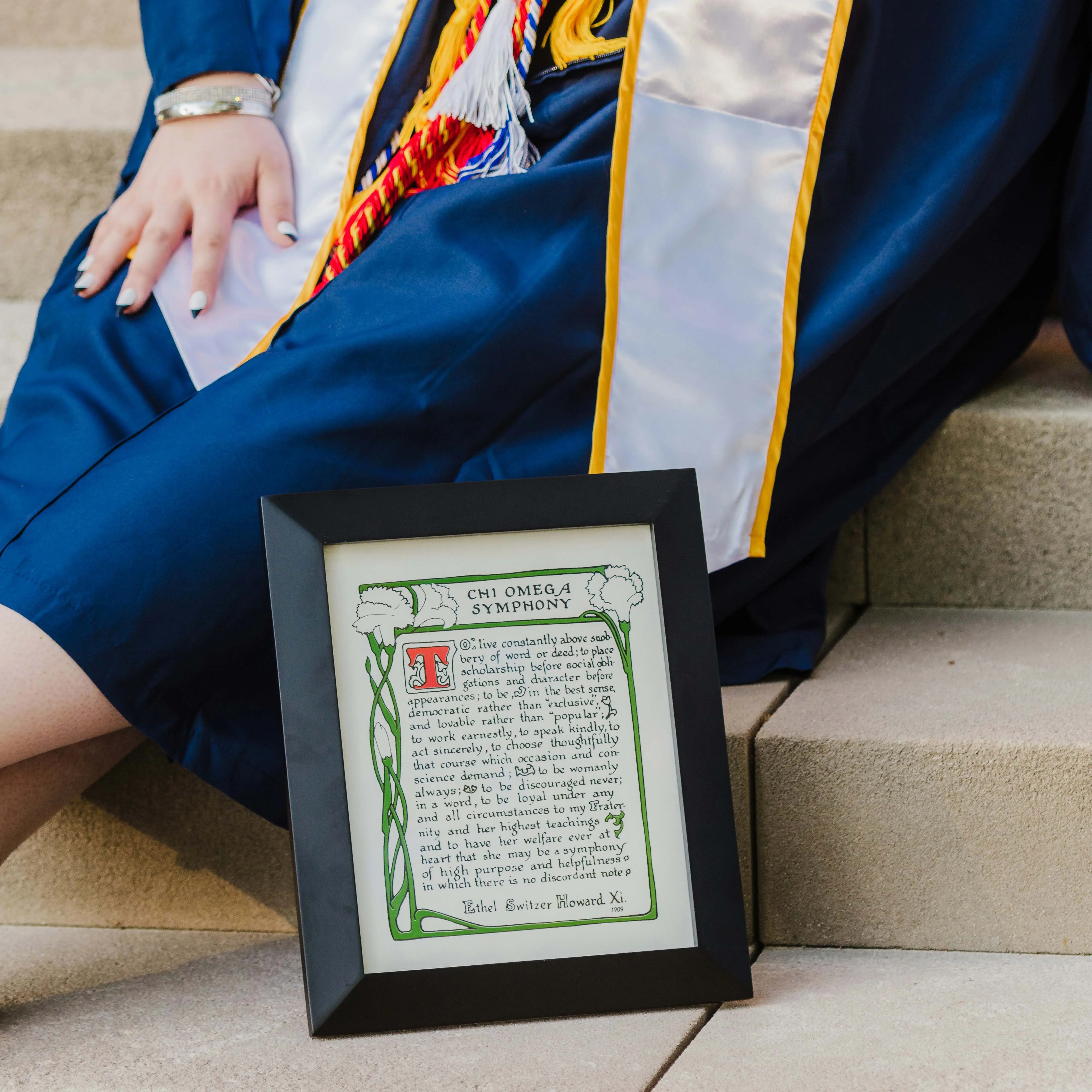 Graduate holding cap and gown memories
