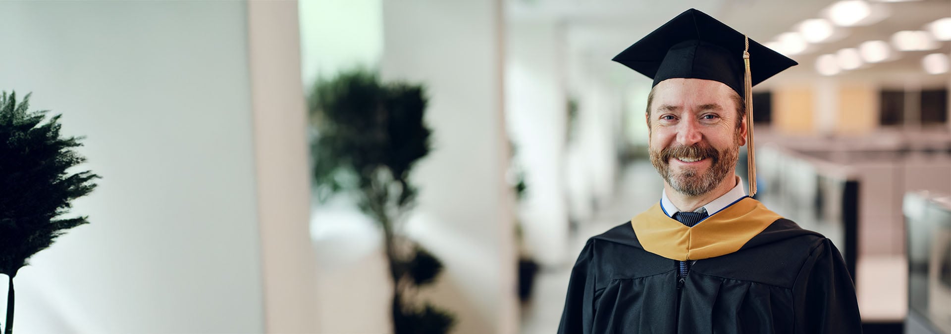 Faculty member wearing academic graduation regalia and hood