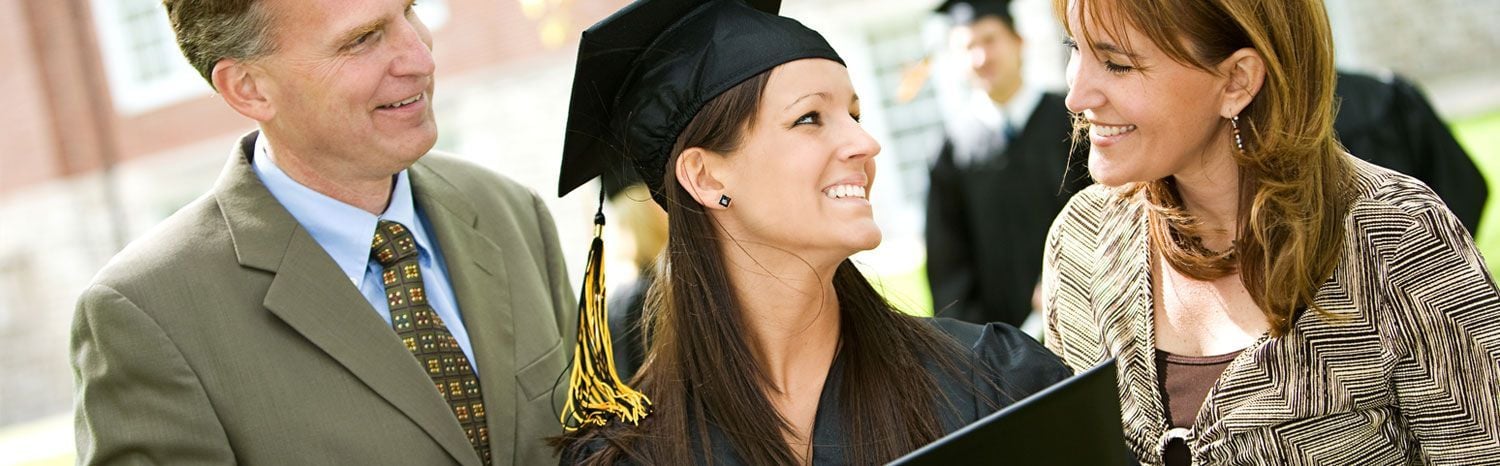young girl graduating with parents