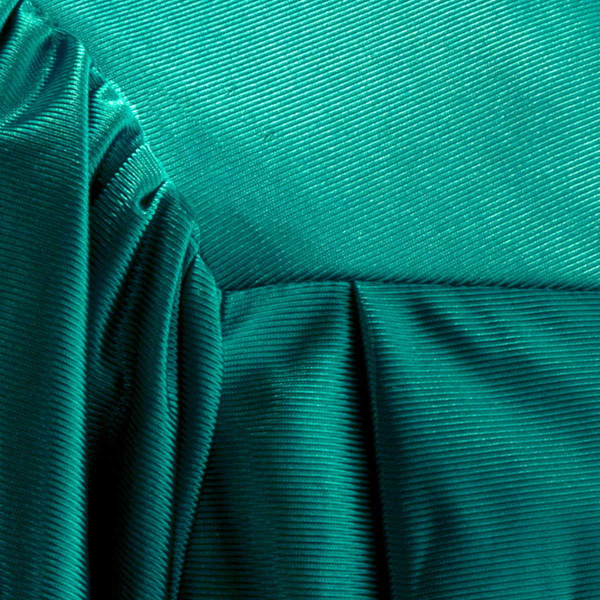 Close view of shiny Emerald Green graduation gown fabric